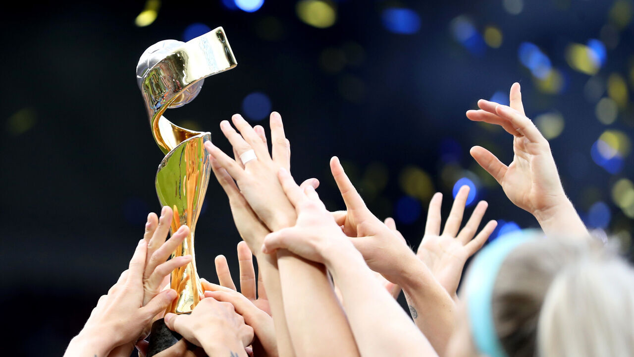 LYON, FRANCE - JULY 07: General view as the players reach for the trophy in the air after the 2019 FIFA Women's World Cup France Final match between The United State of America and The Netherlands at Stade de Lyon on July 07, 2019 in Lyon, France.