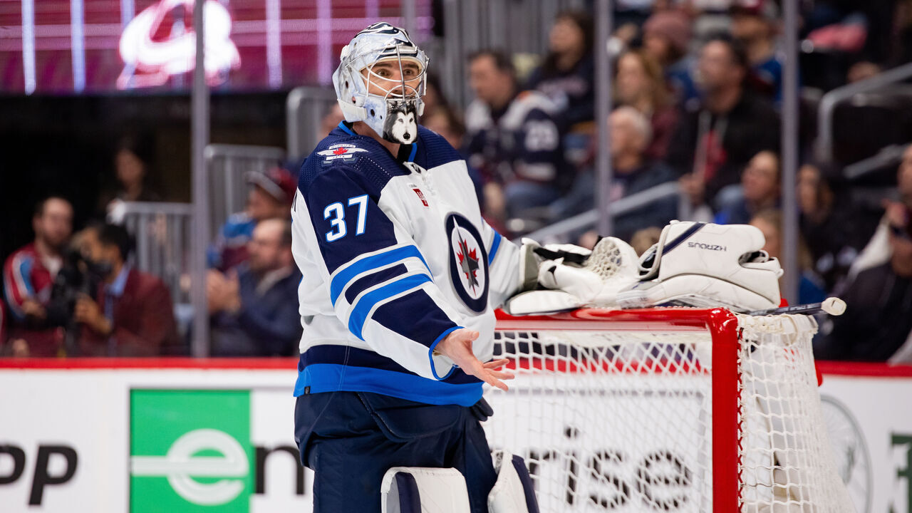 DENVER, COLORADO - APRIL 28: Connor Hellebuyck #37 of the Winnipeg Jets gestures to the referee during a pause in Game Four of the First Round of the Stanley Cup Playoffs against the Colorado Avalanche at Ball Arena on April 28, 2024 in Denver, Colorado.