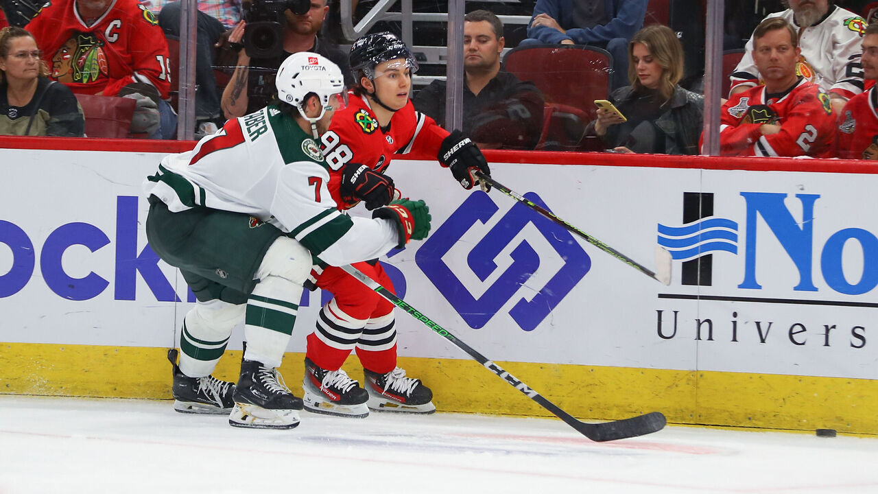 CHICAGO, IL - OCTOBER 05: Minnesota Wild defenseman Brock Faber (7) skates against Chicago Blackhawks center Connor Bedard (98) during a game between the Minnesota Wild and the Chicago Blackhawks on October 5, 2023 at the United Center in Chicago, IL.