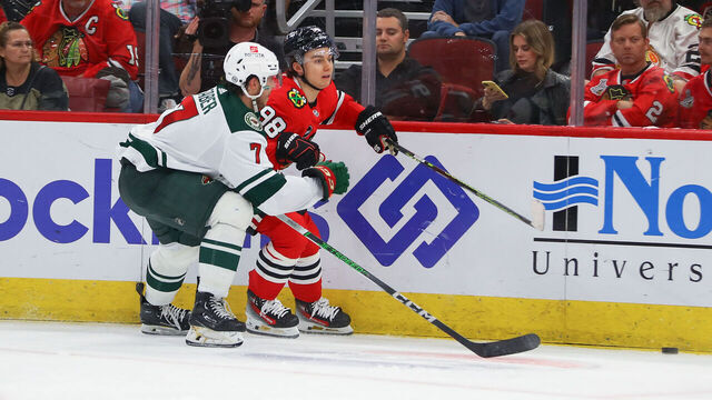 CHICAGO, IL - OCTOBER 05: Minnesota Wild defenseman Brock Faber (7) skates against Chicago Blackhawks center Connor Bedard (98) during a game between the Minnesota Wild and the Chicago Blackhawks on October 5, 2023 at the United Center in Chicago, IL.