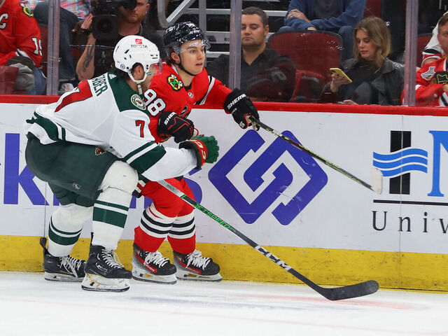 CHICAGO, IL - OCTOBER 05: Minnesota Wild defenseman Brock Faber (7) skates against Chicago Blackhawks center Connor Bedard (98) during a game between the Minnesota Wild and the Chicago Blackhawks on October 5, 2023 at the United Center in Chicago, IL.