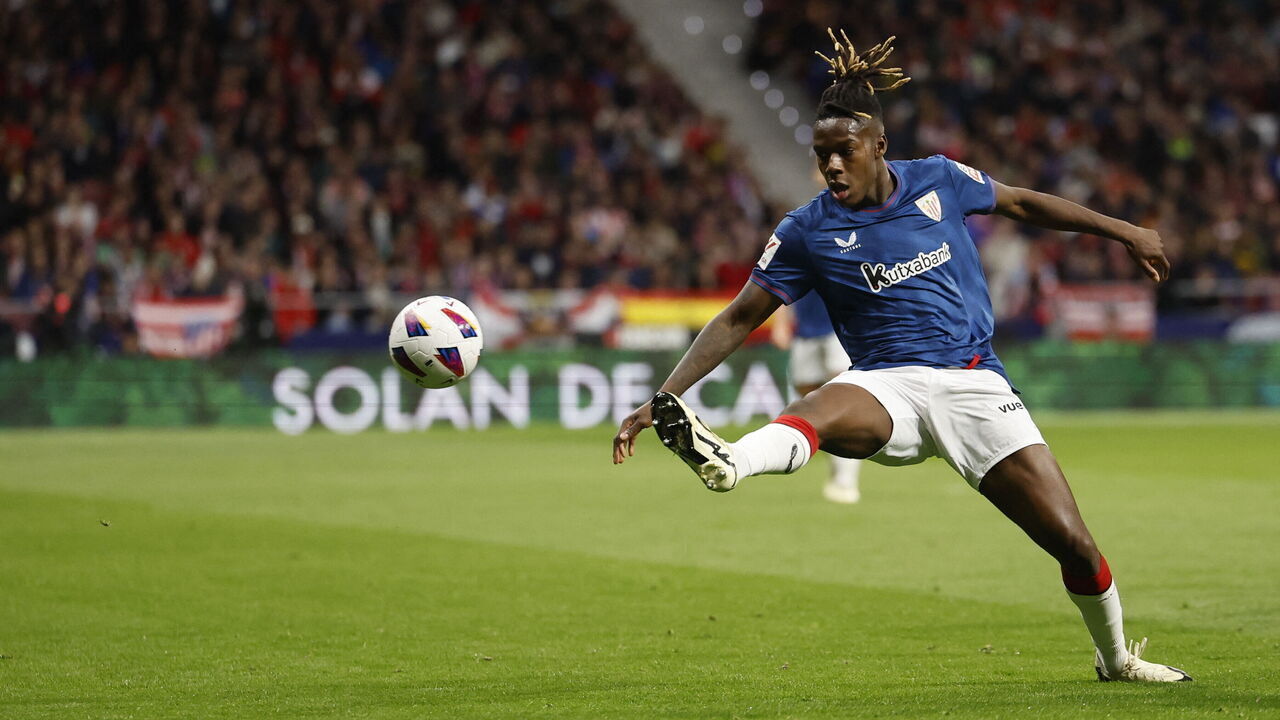 Athletic Bilbao's Spanish forward #11 Nico Williams kicks the ball during the Spanish league football match between Club Atletico de Madrid and Athletic Club Bilbao at the Metropolitano stadium in Madrid on April 27, 2024.