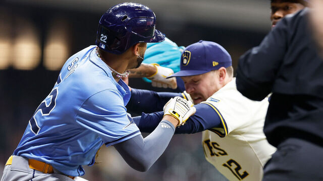 MILWAUKEE, WISCONSIN - APRIL 30: Rhys Hoskins #12 of the Milwaukee Brewers holds back Jose Siri #22 of the Tampa Bay Rays who attempts to go after pitcher Abner Uribe #45 of the Milwaukee Brewers in the eighth inning at American Family Field on April 30, 2024 in Milwaukee, Wisconsin.
