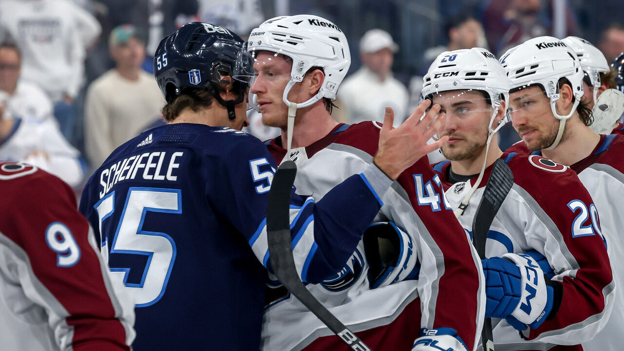 WINNIPEG, CANADA - APRIL 30: Mark Scheifele #55 of the Winnipeg Jets embraces Josh Manson #42 of the Colorado Avalanche in the handshake line following a 6-3 victory by the Avalanche in Game Five of the First Round of the 2024 Stanley Cup Playoffs at the Canada Life Centre on April 30, 2024 in Winnipeg, Manitoba, Canada. The Avalanche win the series 4-1.