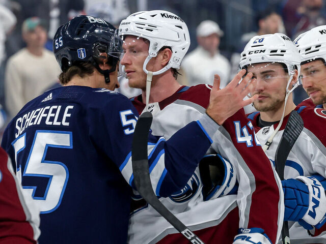 WINNIPEG, CANADA - APRIL 30: Mark Scheifele #55 of the Winnipeg Jets embraces Josh Manson #42 of the Colorado Avalanche in the handshake line following a 6-3 victory by the Avalanche in Game Five of the First Round of the 2024 Stanley Cup Playoffs at the Canada Life Centre on April 30, 2024 in Winnipeg, Manitoba, Canada. The Avalanche win the series 4-1.