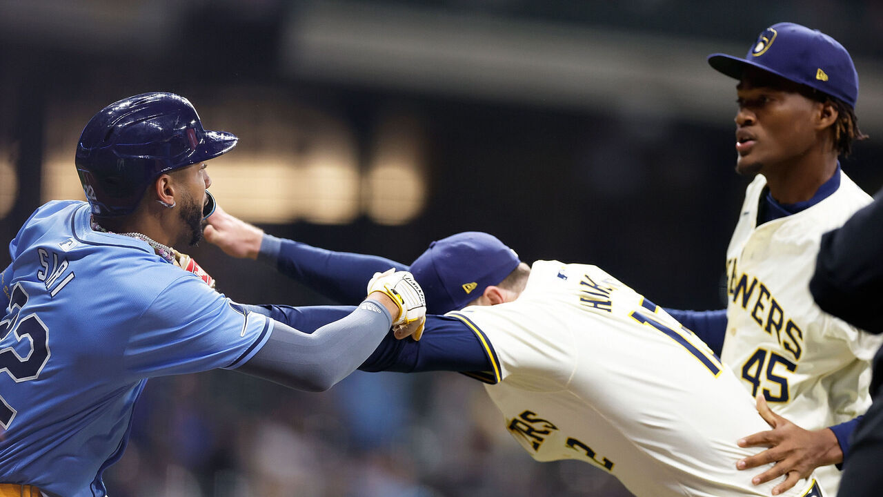 MILWAUKEE, WISCONSIN - APRIL 30: Rhys Hoskins #12 of the Milwaukee Brewers holds back Jose Siri #22 of the Tampa Bay Rays who attempts to go after pitcher Abner Uribe #45 of the Milwaukee Brewers in the eighth inning at American Family Field on April 30, 2024 in Milwaukee, Wisconsin.