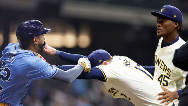 MILWAUKEE, WISCONSIN - APRIL 30: Rhys Hoskins #12 of the Milwaukee Brewers holds back Jose Siri #22 of the Tampa Bay Rays who attempts to go after pitcher Abner Uribe #45 of the Milwaukee Brewers in the eighth inning at American Family Field on April 30, 2024 in Milwaukee, Wisconsin.