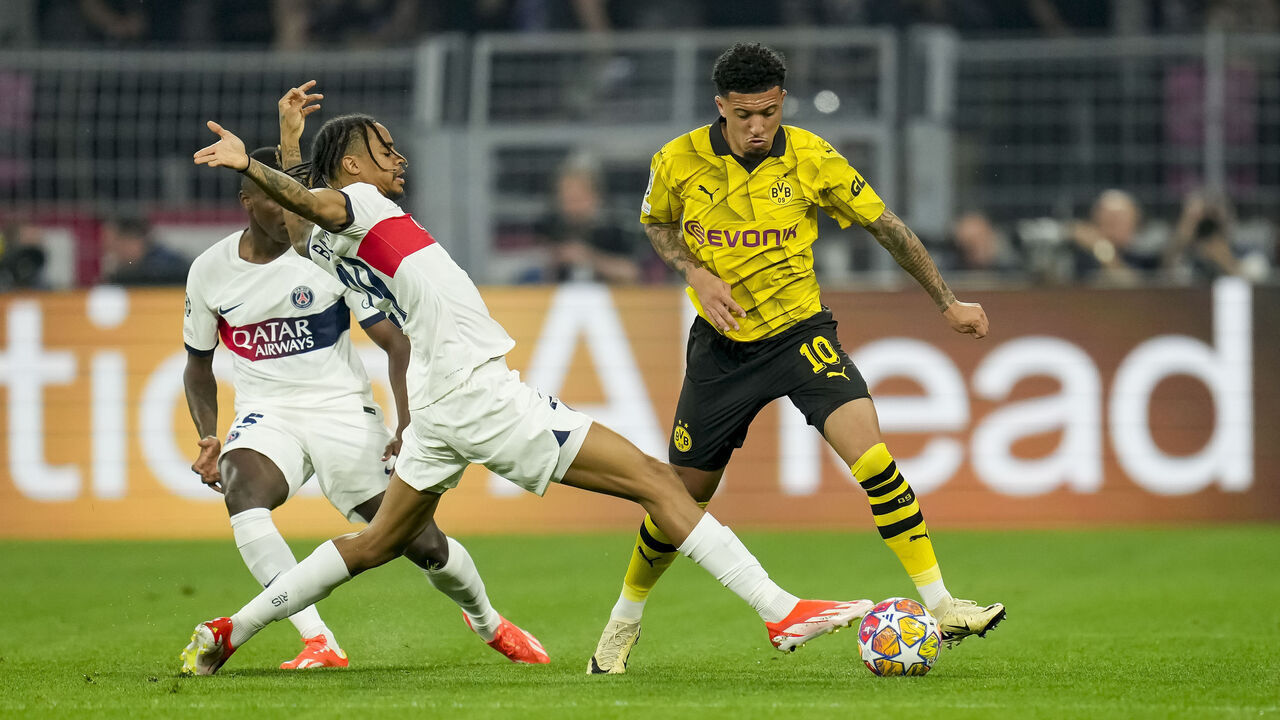 DORTMUND, GERMANY - MAY 1: Nuno Mendes of Paris Saint-Germain, Bradley Barcola of Paris Saint-Germain and Jadon Sancho of Borussia Dortmund battle for the ball during the UEFA Champions League semi-final first leg match between Borussia Dortmund and Paris Saint-Germain at Signal Iduna Park on May 1, 2024 in Dortmund, Germany.