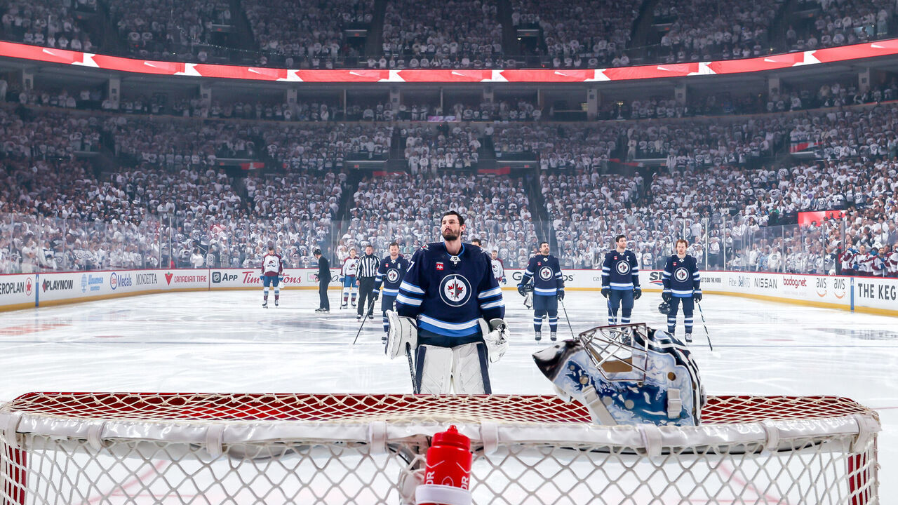 WINNIPEG, CANADA - APRIL 30: Goaltender Connor Hellebuyck #37 of the Winnipeg Jets looks on during the singing of 'O Canada' prior to NHL action against the Colorado Avalanche in Game Five of the First Round of the 2024 Stanley Cup Playoffs at the Canada Life Centre on April 30, 2024 in Winnipeg, Manitoba, Canada.