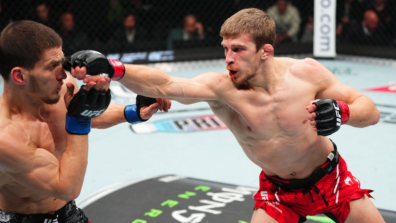 TORONTO, ONTARIO - JANUARY 20: (R-L) Arnold Allen of England punches Movsar Evloev of Russia in a featherweight bout during the UFC 297 event at Scotiabank Arena on January 20, 2024 in Toronto, Ontario.
