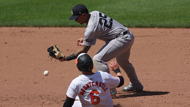 BALTIMORE, MARYLAND - MAY 02: Gleyber Torres #25 of the New York Yankees cannot force the out on Ryan Mountcastle #6 of the Baltimore Orioles during the fifth inning at Oriole Park at Camden Yards on May 2, 2024 in Baltimore, Maryland.