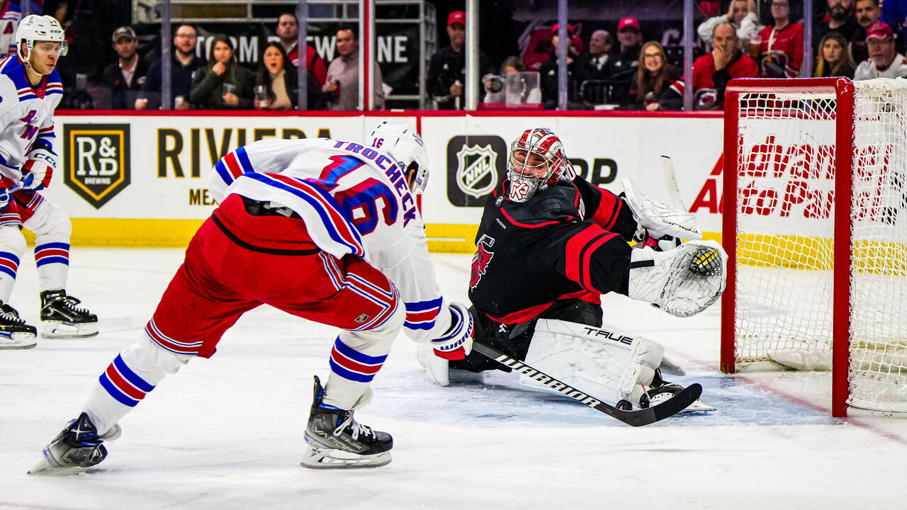 RALEIGH, NORTH CAROLINA - MARCH 12: Pyotr Kochetkov #52 of the Carolina Hurricanes makes a save against Vincent Trocheck #16 of the New York Rangers during the third period at PNC Arena on March 12, 2024 in Raleigh, North Carolina.