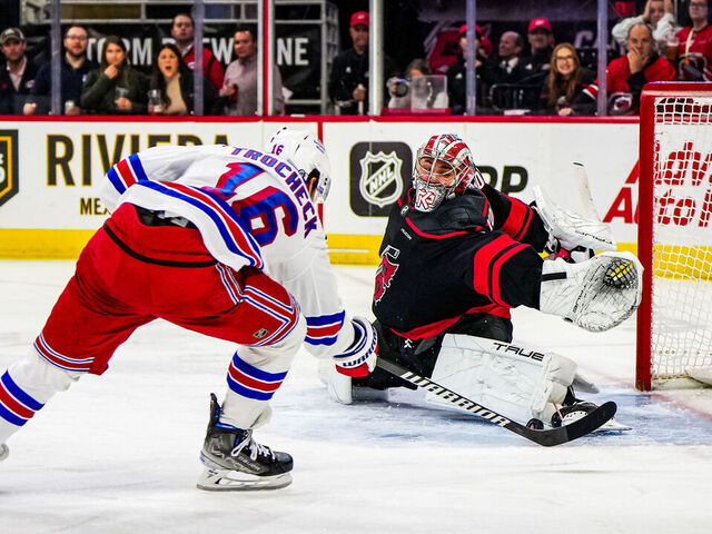 RALEIGH, NORTH CAROLINA - MARCH 12: Pyotr Kochetkov #52 of the Carolina Hurricanes makes a save against Vincent Trocheck #16 of the New York Rangers during the third period at PNC Arena on March 12, 2024 in Raleigh, North Carolina.