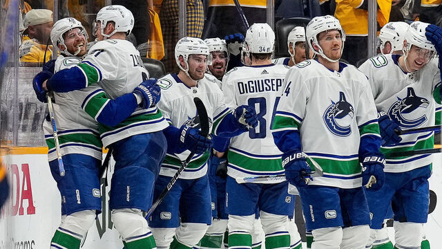 NASHVILLE, TENNESSEE - APRIL 28: Elias Lindholm #23 celebrates his overtime game winning goal with Nikita Zadorov #91 of the Vancouver Canucks against the Nashville Predators in Game Four of the First Round of the 2024 Stanley Cup Playoffs at Bridgestone Arena on April 28, 2024 in Nashville, Tennessee.