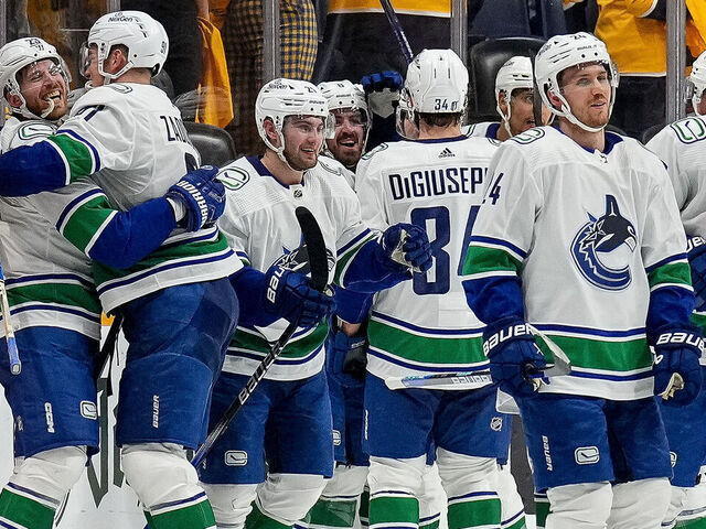NASHVILLE, TENNESSEE - APRIL 28: Elias Lindholm #23 celebrates his overtime game winning goal with Nikita Zadorov #91 of the Vancouver Canucks against the Nashville Predators in Game Four of the First Round of the 2024 Stanley Cup Playoffs at Bridgestone Arena on April 28, 2024 in Nashville, Tennessee.