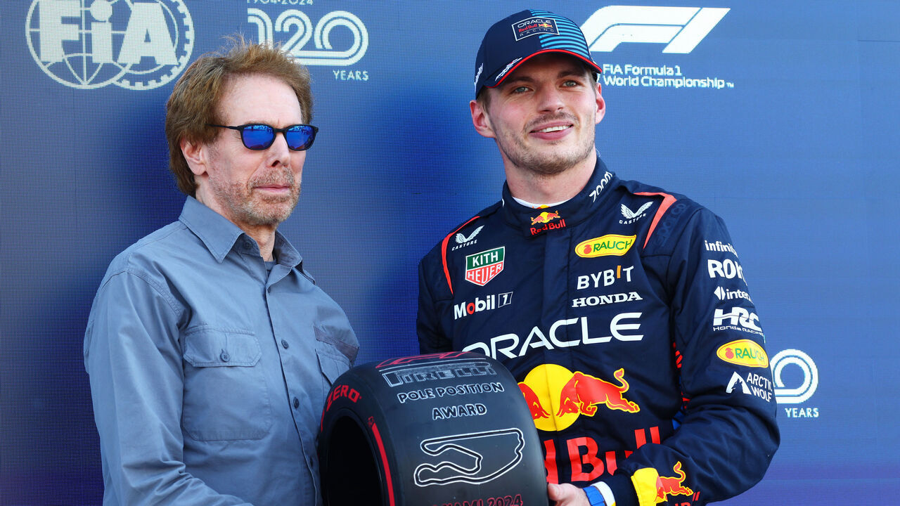 MIAMI, FLORIDA - MAY 04: Pole position qualifier Max Verstappen of the Netherlands and Oracle Red Bull Racing is presented with the Pirelli Pole Position Award by Jerry Bruckheimer, producer of the upcoming Formula One based movie, Apex, in parc ferme during qualifying ahead of the F1 Grand Prix of Miami at Miami International Autodrome on May 04, 2024 in Miami, Florida.