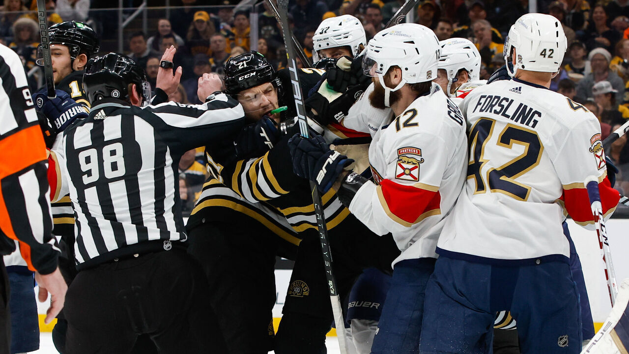 BOSTON, MASSACHUSETTS - APRIL 6: Linesman Dan Kelly #98 tries to step between James van Riemsdyk #21 of the Boston Bruins and Jonah Gadjovich #12 of the Florida Panthers during the first period as they push each other during a game at the TD Garden on April 6, 2024 in Boston, Massachusetts. The Bruins won 3-2 in overtime.