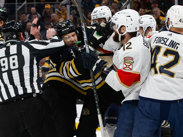 BOSTON, MASSACHUSETTS - APRIL 6: Linesman Dan Kelly #98 tries to step between James van Riemsdyk #21 of the Boston Bruins and Jonah Gadjovich #12 of the Florida Panthers during the first period as they push each other during a game at the TD Garden on April 6, 2024 in Boston, Massachusetts. The Bruins won 3-2 in overtime.