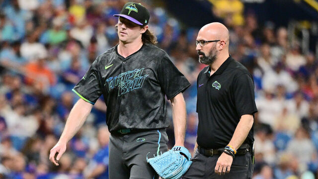 ST PETERSBURG, FLORIDA - MAY 05: Ryan Pepiot #44 of the Tampa Bay Rays walks off the field with trainer Joseph Benge after getting hit by a batted ball in the third inning against the New York Mets at Tropicana Field on May 05, 2024 in St Petersburg, Florida.