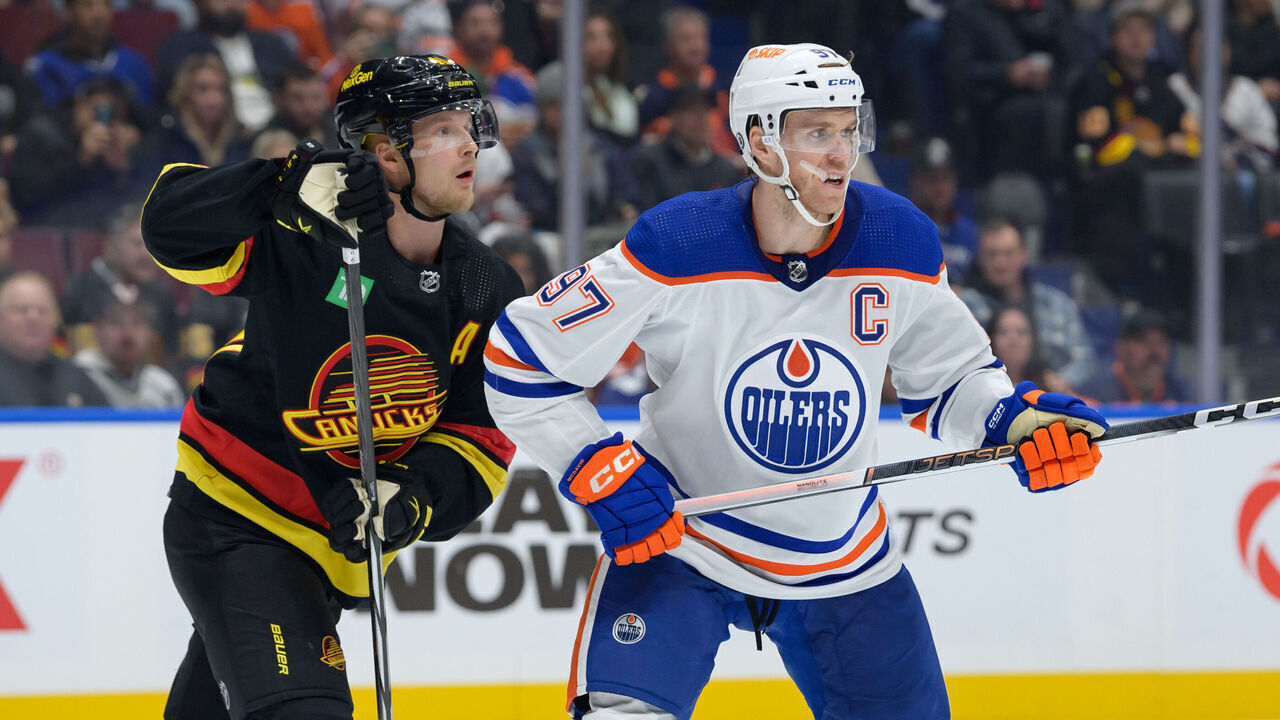 VANCOUVER, CANADA - NOVEMBER 6: Elias Pettersson #40 of the Vancouver Canucks and Connor McDavid #97 of the Edmonton Oilers skates up ice during the second period of their NHL game at Rogers Arena on November 6, 2023 in Vancouver, British Columbia, Canada.
