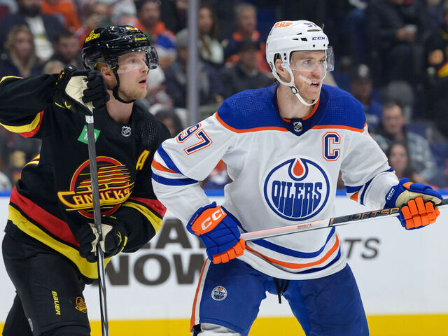VANCOUVER, CANADA - NOVEMBER 6: Elias Pettersson #40 of the Vancouver Canucks and Connor McDavid #97 of the Edmonton Oilers skates up ice during the second period of their NHL game at Rogers Arena on November 6, 2023 in Vancouver, British Columbia, Canada.
