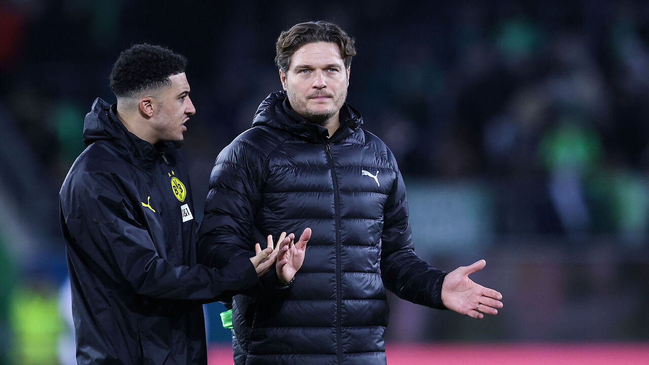Dortmund's German head coach Edin Terzic (R) chats with British midfielder #10 Jadon Sancho at the end of the German first division Bundesliga football match between VfL Wolfsburg and BVB Borussia Dortmund in Wolfsburg, western Germany on February 17, 2024.