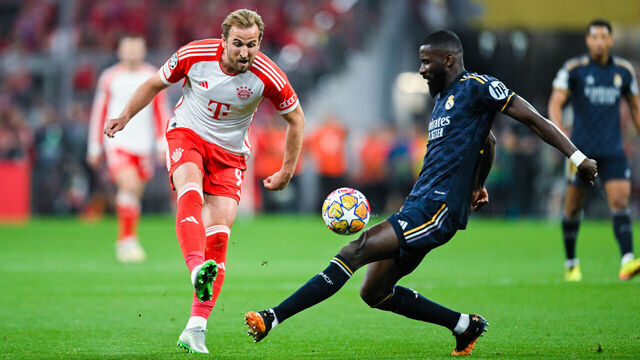 MUNICH, GERMANY - APRIL 30: Harry Kane of Bayern Muenchen and Antonio Ruediger of Real Madrid battle for the ball during the UEFA Champions League semi-final first leg match between FC Bayern München and Real Madrid at Allianz Arena on April 30, 2024 in Munich, Germany.