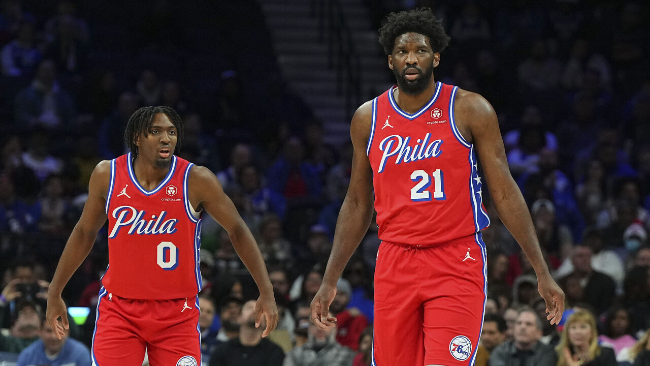 PHILADELPHIA, PENNSYLVANIA - DECEMBER 8: Tyrese Maxey #0 and Joel Embiid #21 of the Philadelphia 76ers look on against the Atlanta Hawks at the Wells Fargo Center on December 8, 2023 in Philadelphia, Pennsylvania.