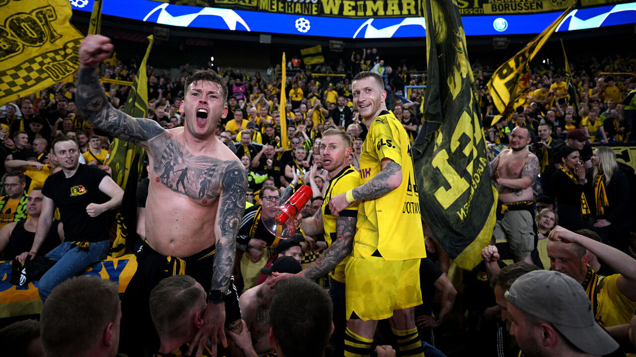 PARIS, FRANCE - MAY 07: Marco Reus of Borussia Dortmund celebrates victory with fans of Borussia Dortmund after defeating Paris Saint-Germain during the UEFA Champions League semi-final second leg match between Paris Saint-Germain and Borussia Dortmund at Parc des Princes on May 07, 2024 in Paris, France.