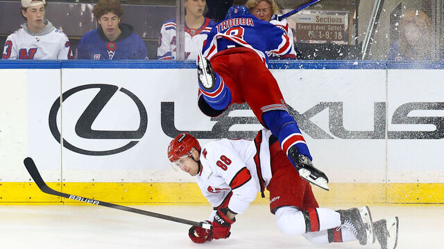 NEW YORK, NY - MAY 07: New York Rangers Defenseman Jacob Trouba (8) slams head-first into the glass during the first overtime in Game 2 of the National Hockey League Stanley Cup Playoffs Eastern Conference Second Round game between the Carolina Hurricanes and the New York Rangers on May 7, 2024 at Madison Square Garden in New York, NY.