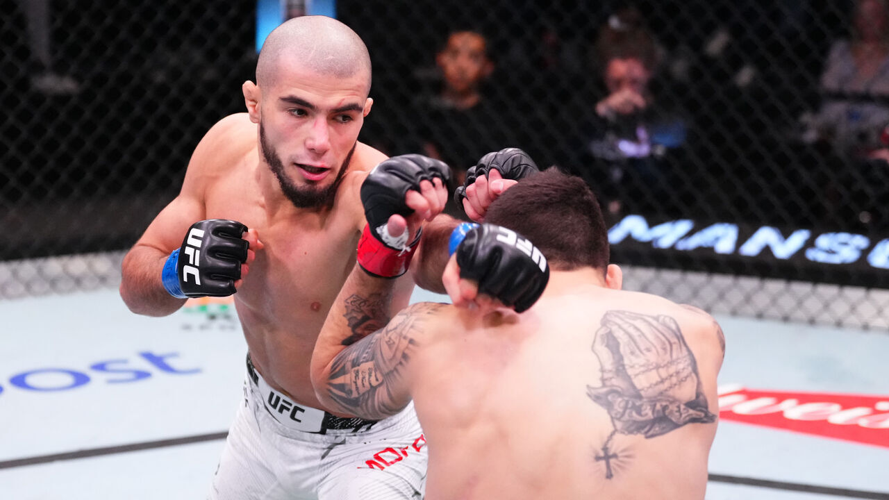 LAS VEGAS, NEVADA - MARCH 02: (L-R) Muhammad Mokaev of Russia punches Alex Perez in a flyweight bout during the UFC Fight Night event at UFC APEX on March 02, 2024 in Las Vegas, Nevada.