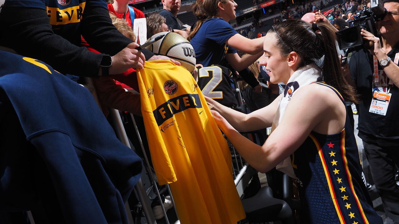 INDIANAPOLIS, IN - MAY 9: Caitlin Clark #22 of the Indiana Fever autographs after the game against the Atlanta Dream on May 9, 2024 at Gainbridge Fieldhouse in Indianapolis, Indiana. Mandatory Copyright Notice: Copyright 2024 NBAE