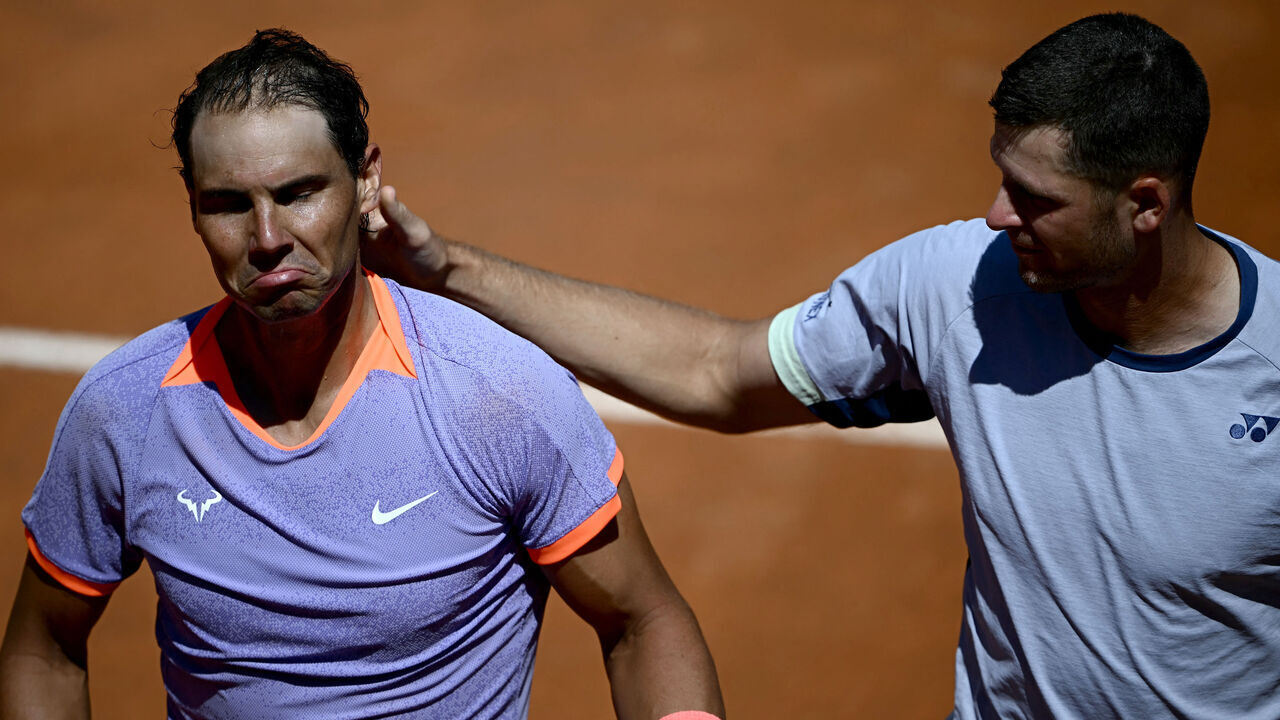 TOPSHOT - Spain's Rafael Nadal (L) looks dejected after being eliminated by Poland's Hubert Hurkacz during the Men's ATP Rome Open tennis tournament at Foro Italico in Rome on May 11, 2024.
