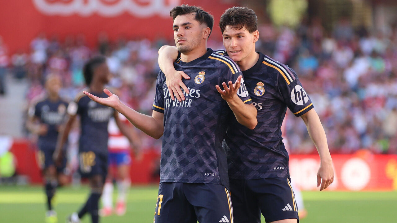 GRANADA, SPAIN - MAY 11: Brahim Diaz of Real Madrid celebrates scoring his team's fourth goal with teammate Fran Garcia during the LaLiga EA Sports match between Granada CF and Real Madrid CF at Estadio Nuevo Los Carmenes on May 11, 2024 in Granada, Spain.