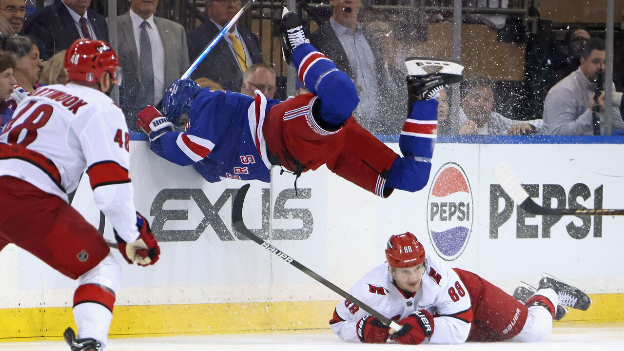 NEW YORK, NEW YORK - MAY 07: Jacob Trouba #8 of the New York Rangers jumps over Martin Necas #88 of the Carolina Hurricanes during the third period in Game Two of the Second Round of the 2024 Stanley Cup Playoffs at Madison Square Garden on May 07, 2024 in New York City.
