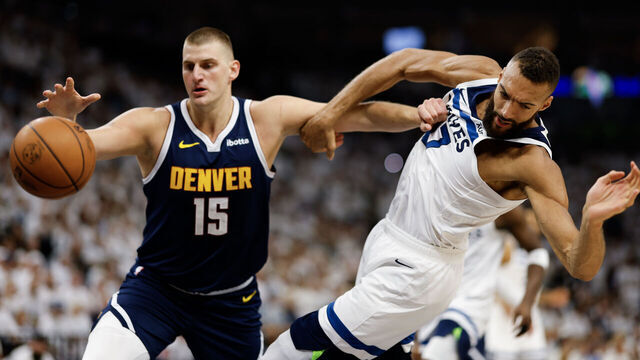 MINNEAPOLIS, MINNESOTA - MAY 12: Rudy Gobert #27 of the Minnesota Timberwolves looses the ball while defended by Nikola Jokic #15 of the Denver Nuggets during the first quarter in Game Four of the Western Conference Second Round Playoffs at Target Center on May 12, 2024 in Minneapolis, Minnesota.