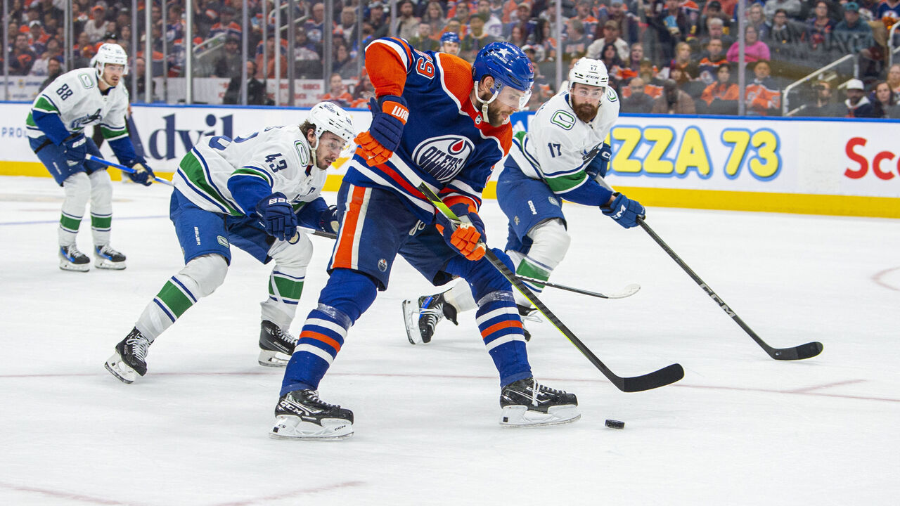 EDMONTON, ALBERTA - MAY 12: Leon Draisaitl #29 of the Edmonton Oilers battles for the puck against the Vancouver Canucks during the second period in Game Three of the Second Round of the 2024 Stanley Cup Playoffs at Rogers Place on May 12, 2024 in Edmonton, Alberta, Canada.