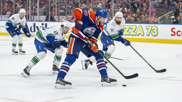 EDMONTON, ALBERTA - MAY 12: Leon Draisaitl #29 of the Edmonton Oilers battles for the puck against the Vancouver Canucks during the second period in Game Three of the Second Round of the 2024 Stanley Cup Playoffs at Rogers Place on May 12, 2024 in Edmonton, Alberta, Canada.