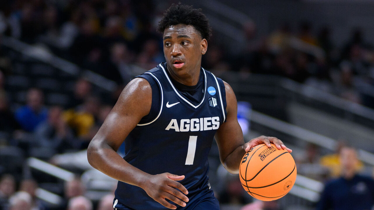 INDIANAPOLIS, IN - MARCH 24: Utah State Aggies forward Great Osobor (1) dribbles into the lane during the Purdue Boilermakers versus the Utah State Aggies in the second round of the NCAA Division 1 Championship on March 24, 2024, at Gainbridge Fieldhouse in Indianapolis, IN.