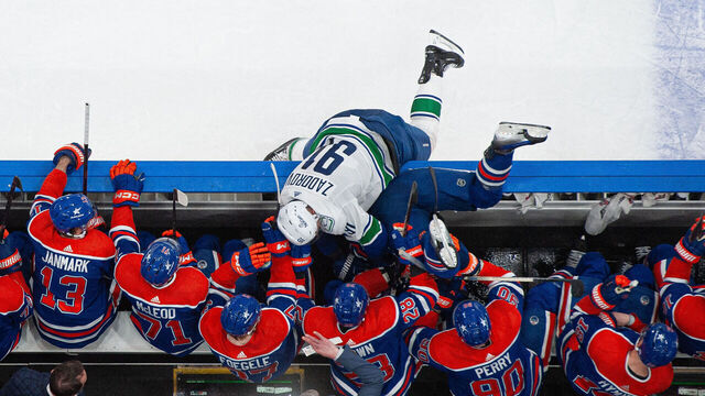 EDMONTON, CANADA - MAY 12: Nikita Zadorov #91 of the Vancouver Canucks shoves Evander Kane #91 of the Edmonton Oilers into the bench in the second period of Game Three of the Second Round of the 2024 Stanley Cup Playoffs at Rogers Place on May 12, 2024, in Edmonton, Alberta, Canada.