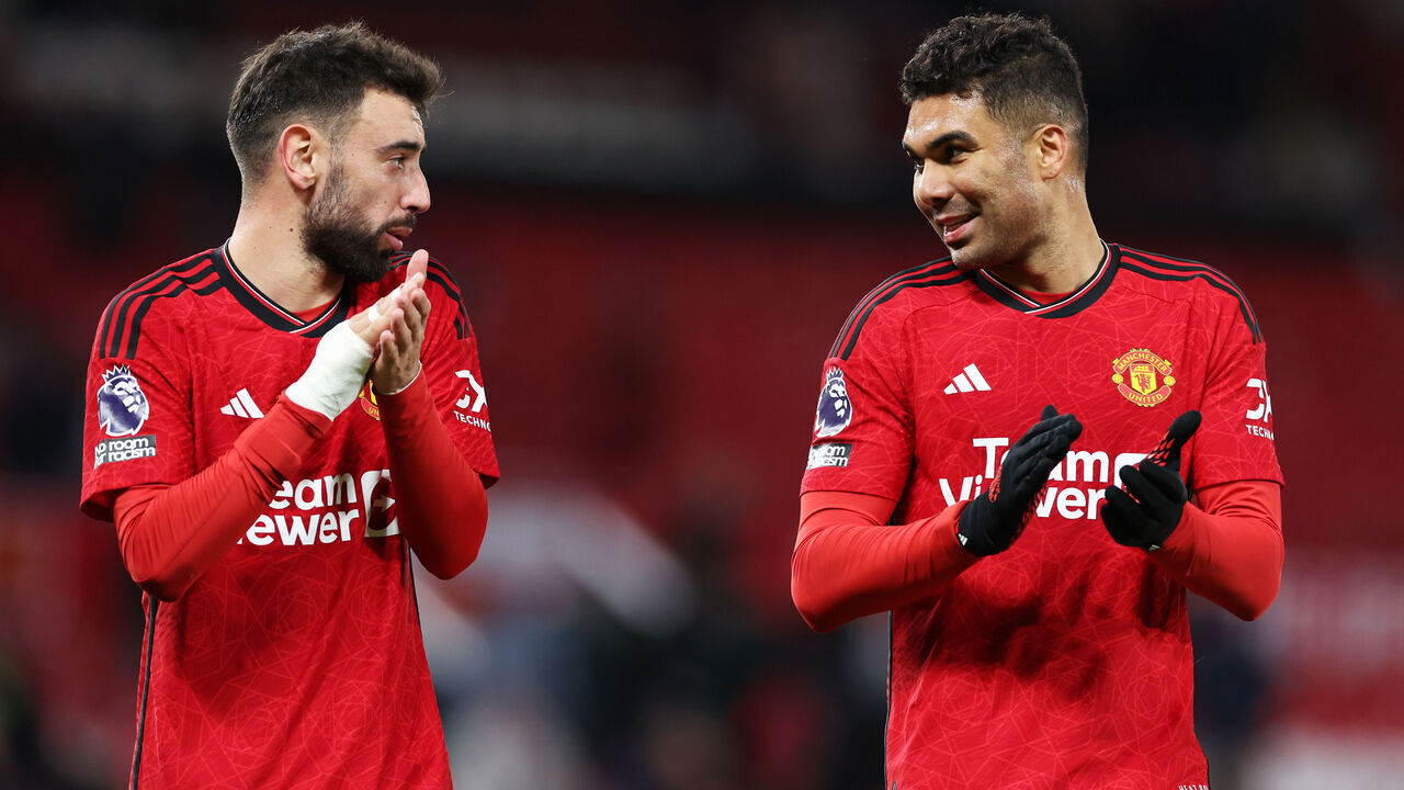 MANCHESTER, ENGLAND - APRIL 24: Bruno Fernandes and Casemiro of Manchester United react as they applaud the fans after the team's victory in the Premier League match between Manchester United and Sheffield United at Old Trafford on April 24, 2024 in Manchester, England.