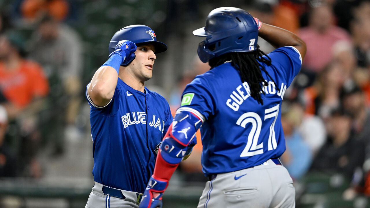 BALTIMORE, MARYLAND - MAY 13: Daulton Varsho #25 of the Toronto Blue Jays celebrates with Vladimir Guerrero Jr. #27 after hitting a home run in the eighth inning against the Baltimore Orioles at Oriole Park at Camden Yards on May 13, 2024 in Baltimore, Maryland.