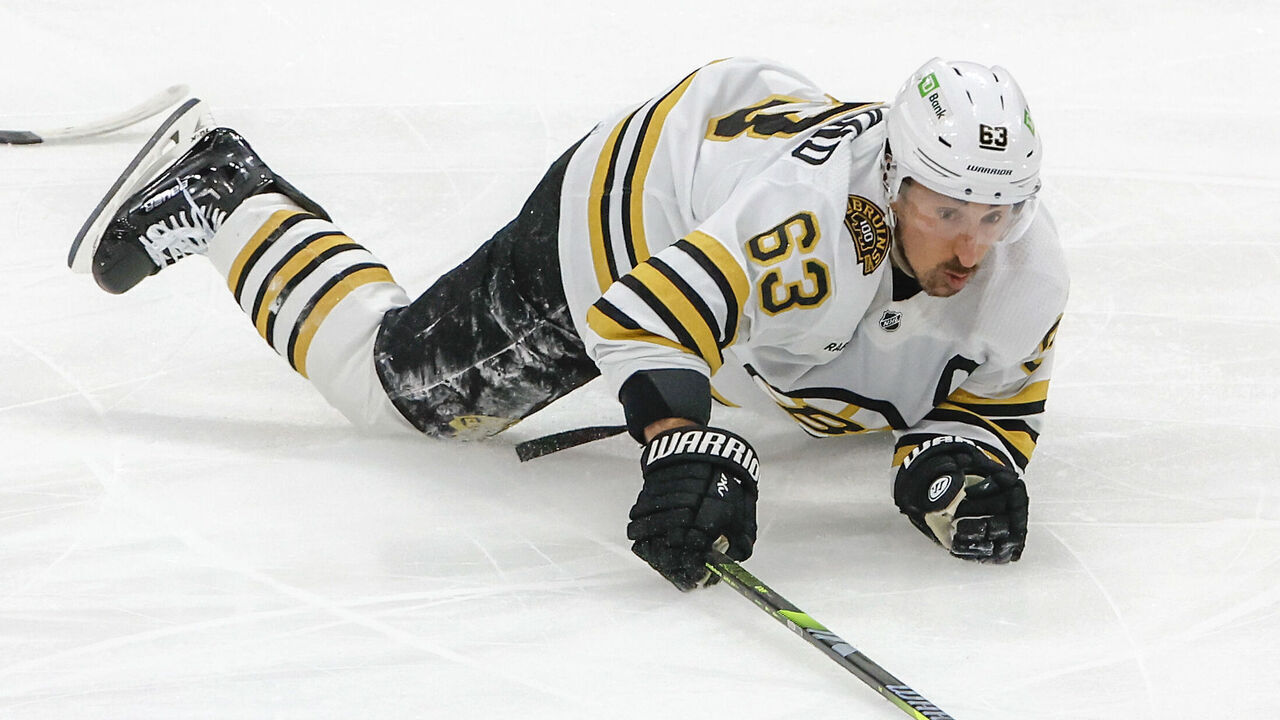 Sunrise, FL - May 8: Boston Bruins LW Brad Marchand controls the puck after getting tripped and penalized by Florida Panthers C Anton Lundell in the first period.