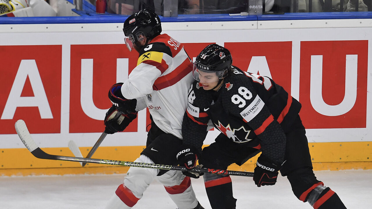 Canada's forward #98 Connor Bedard (R) and Austria's forward #03 Peter Schneider vie for the puck during the IIHF Men's Ice Hockey World Championship match between Canada and Austria in Prague, Czech Republic, on May 14, 2024.
