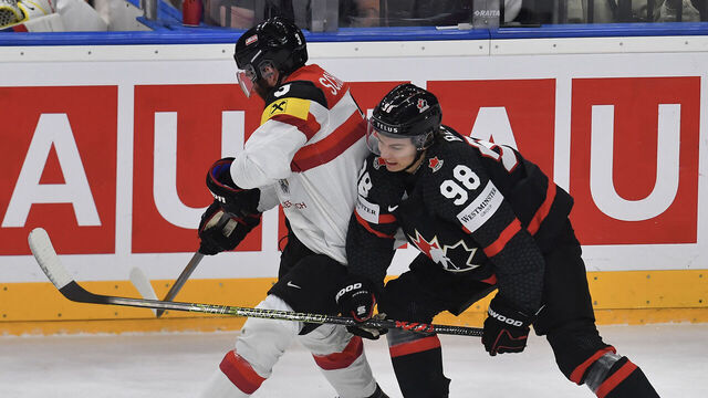 Canada's forward #98 Connor Bedard (R) and Austria's forward #03 Peter Schneider vie for the puck during the IIHF Men's Ice Hockey World Championship match between Canada and Austria in Prague, Czech Republic, on May 14, 2024.