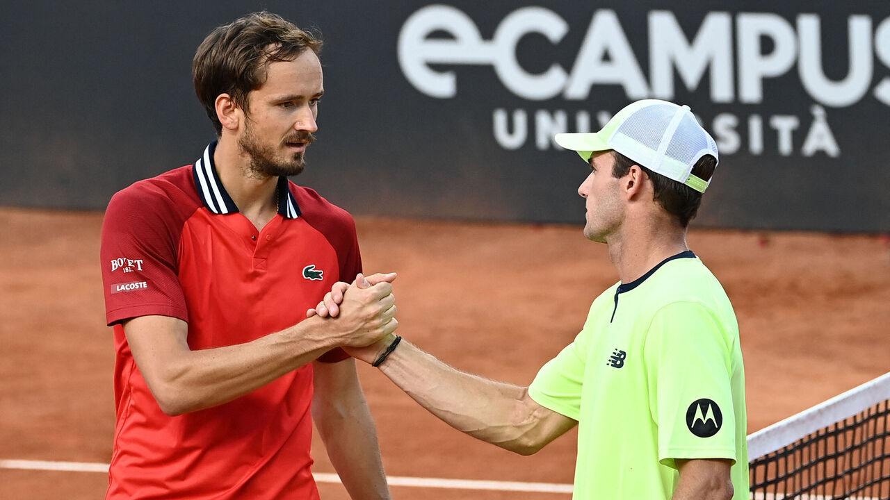 US Tommy Paul (R) shakes hand with Russia's Daniil Medvedev (L) after winning the match during the Men's ATP Rome Open tennis tournament at Foro Italico in Rome on May 14, 2024.