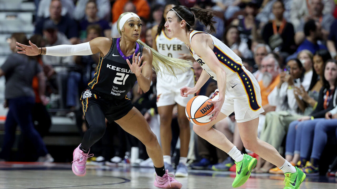 UNCASVILLE, CONNECTICUT - MAY 14: Caitlin Clark #22 of the Indiana Fever dribbles the ball against DiJonai Carrington #21 of the Connecticut Sun during the second quarter in the game at Mohegan Sun Arena on May 14, 2024 in Uncasville, Connecticut.