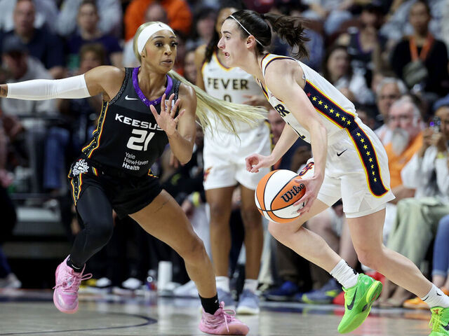 UNCASVILLE, CONNECTICUT - MAY 14: Caitlin Clark #22 of the Indiana Fever dribbles the ball against DiJonai Carrington #21 of the Connecticut Sun during the second quarter in the game at Mohegan Sun Arena on May 14, 2024 in Uncasville, Connecticut.