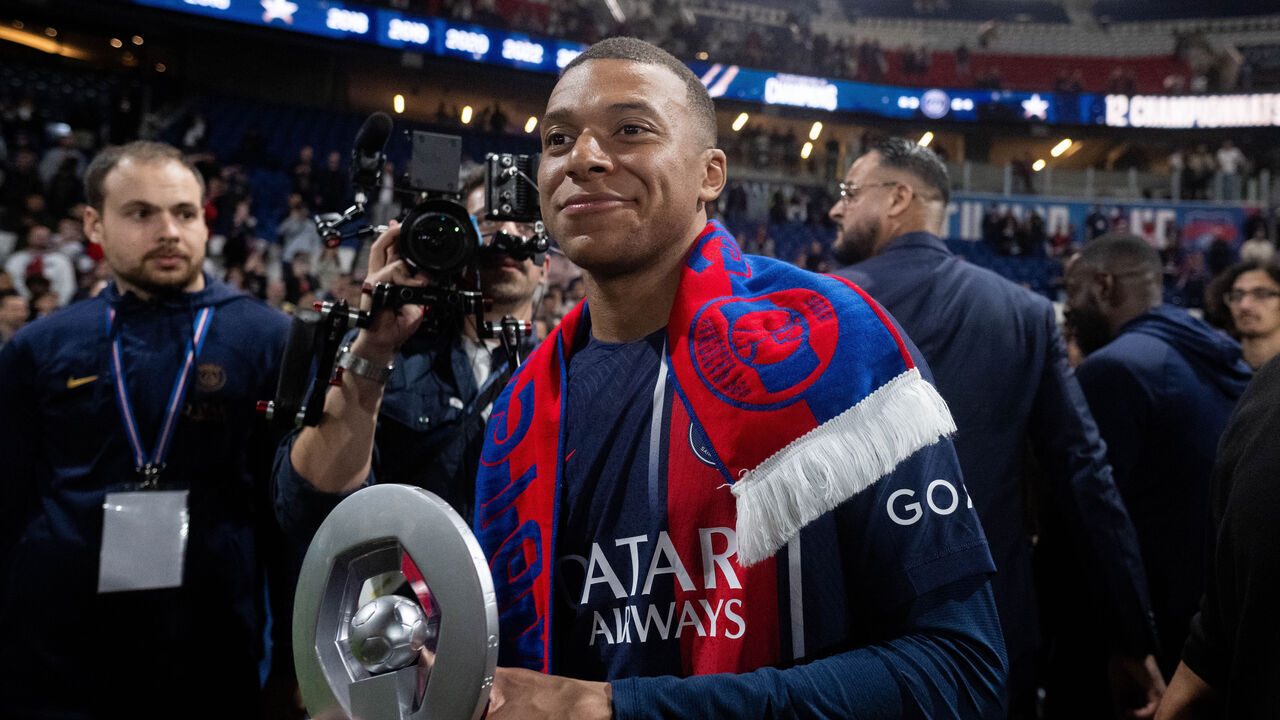 PARIS, FRANCE - MAY 12: Kylian Mbappe of Paris Saint-Germain celebrates with a trophy after winning the French Ligue 1 title during the Ligue 1 Uber Eats match between Paris Saint-Germain and Toulouse FC at Parc des Princes on May 12, 2024 in Paris, France.