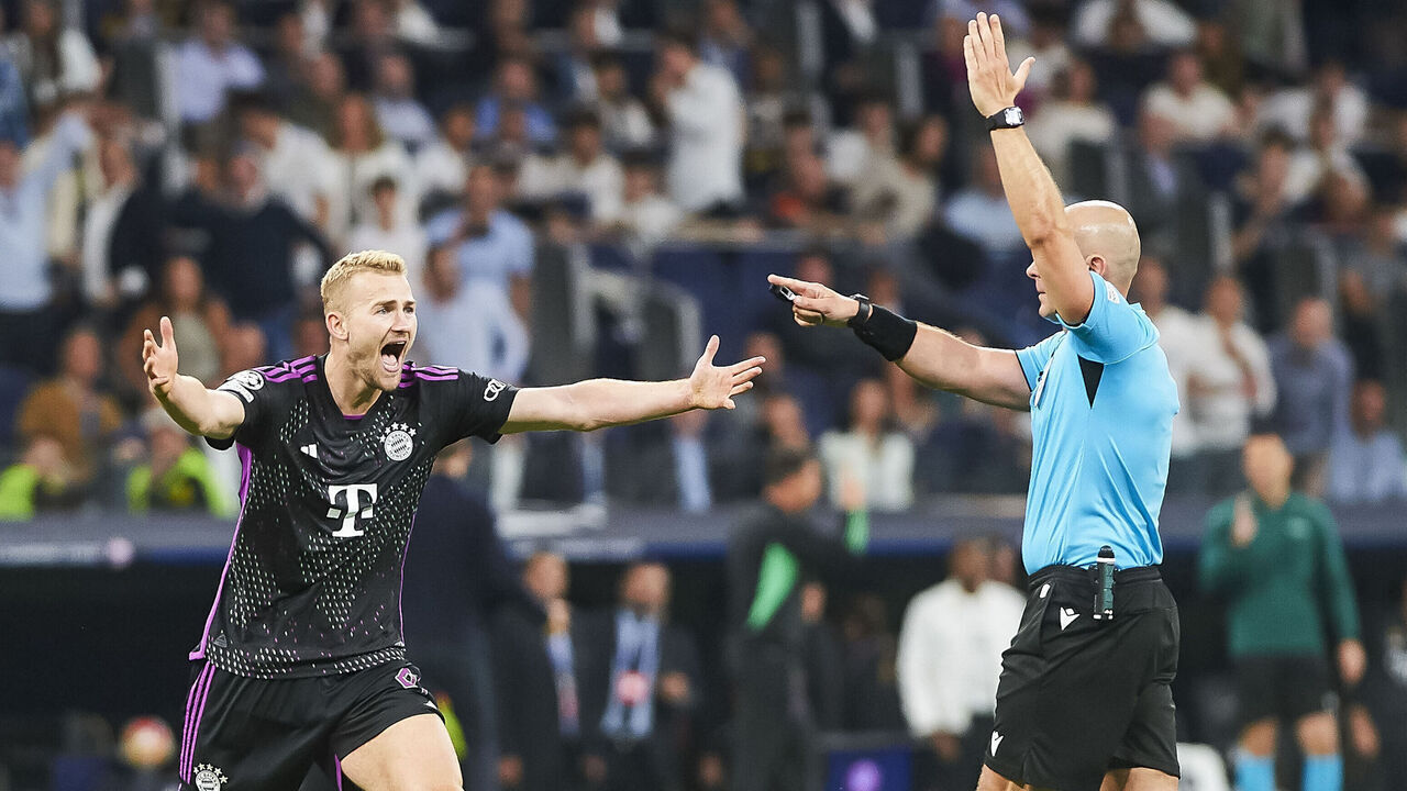 MADRID, SPAIN - MAY 8: Matthijs de Ligt of Bayern Muenchen and referee Szymon Marciniak during the UEFA Champions League semi-final second leg match between Real Madrid and FC Bayern MÃ¼nchen at Estadio Santiago Bernabeu on May 8, 2024 in Madrid, Spain.